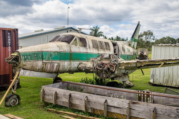 A US military transport plane delivering aid supplies to an airport in a region affected by a natural disaster. Aid workers and local residents are visible unloading the supplies.