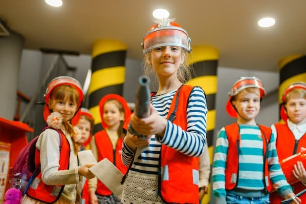 Children in protective helmets and vests practicing a disaster drill in a school, highlighting preparedness and safety, with UNICEF signage visible.