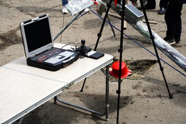 A photograph of a UN disaster response team using satellite phones and laptops in a field office in the US, highlighting the importance of communication and coordination technologies.