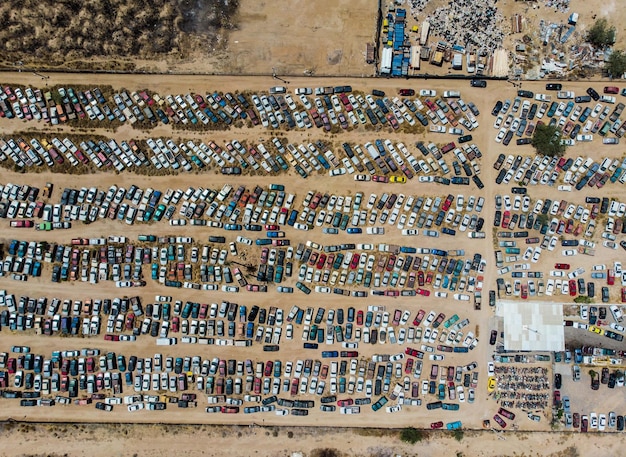 An aerial view of a large international aid distribution center. Boxes are labeled with various aid supplies (food, medicine, water purification kits) and the US flag is prominently displayed on the side of the main warehouse, highlighting the role of US aid in global distribution efforts.