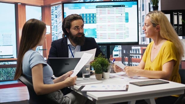 A team in a meeting room, reviewing and planning out each check on a check list.