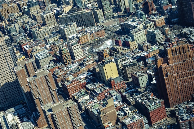An aerial view of a US city severely affected by a hurricane, with an AI-powered drone delivering essential supplies to isolated areas, highlighting the potential benefits and challenges in a disaster scenario.