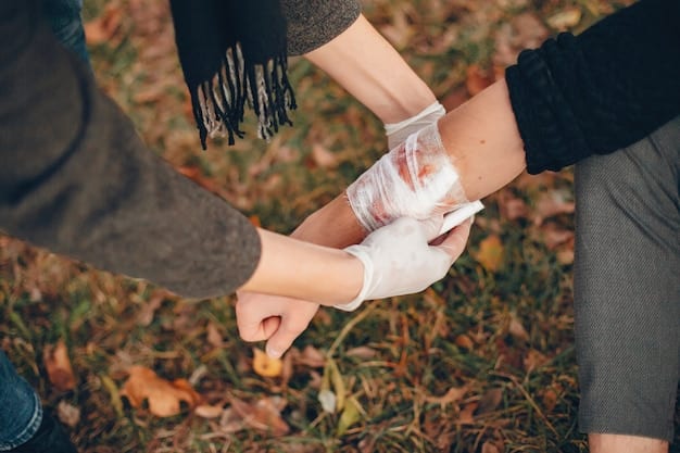 A person applying a bandage to another person's injured arm, highlighting the practical application of first aid skills during a disaster scenario.