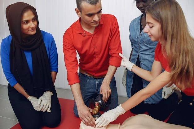 A volunteer participating in a training session on basic first aid and CPR. The volunteer is practicing chest compressions on a dummy, with an instructor providing guidance. The setting is a classroom with other participants observing and learning.