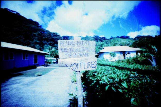 A community rebuilt after a major hurricane, with new, resilient homes and a renewed sense of purpose, showing the recovery phase and community spirit.